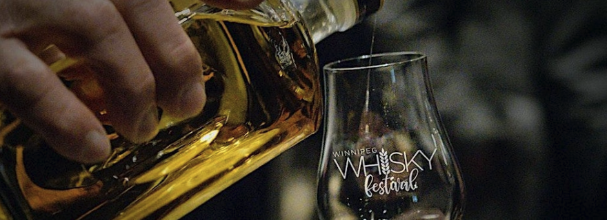 Pouring a glass of whisky in a Winnipeg Whisky Festival glass