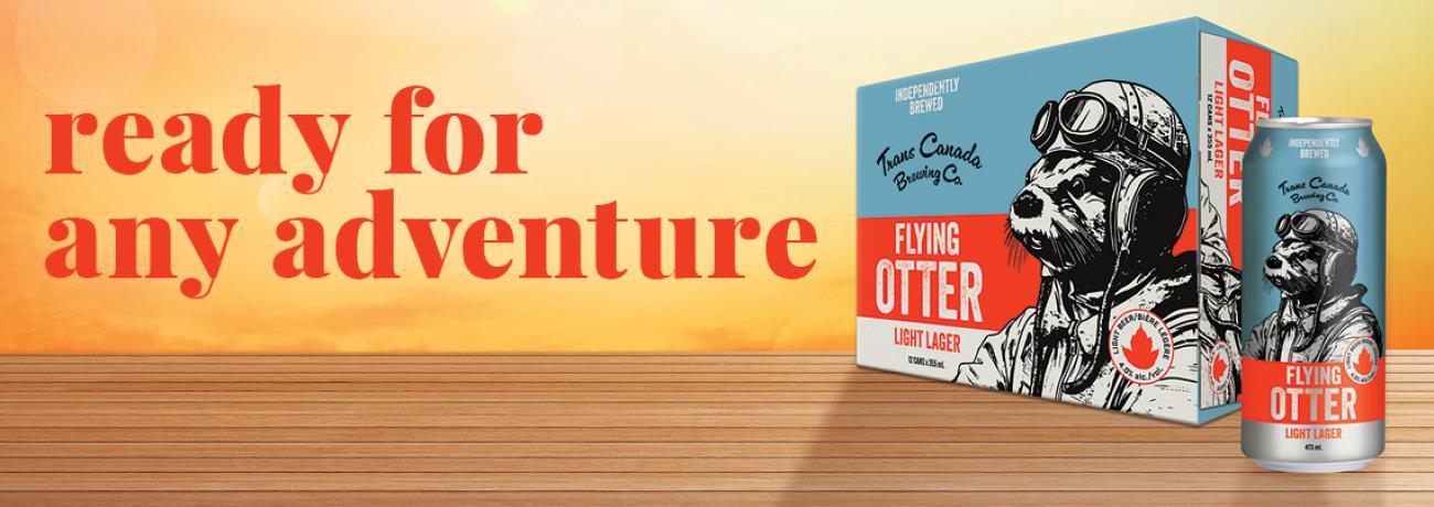 A case of Flying Otter beer sitting on a wooden table. Text: Ready for any adventure.